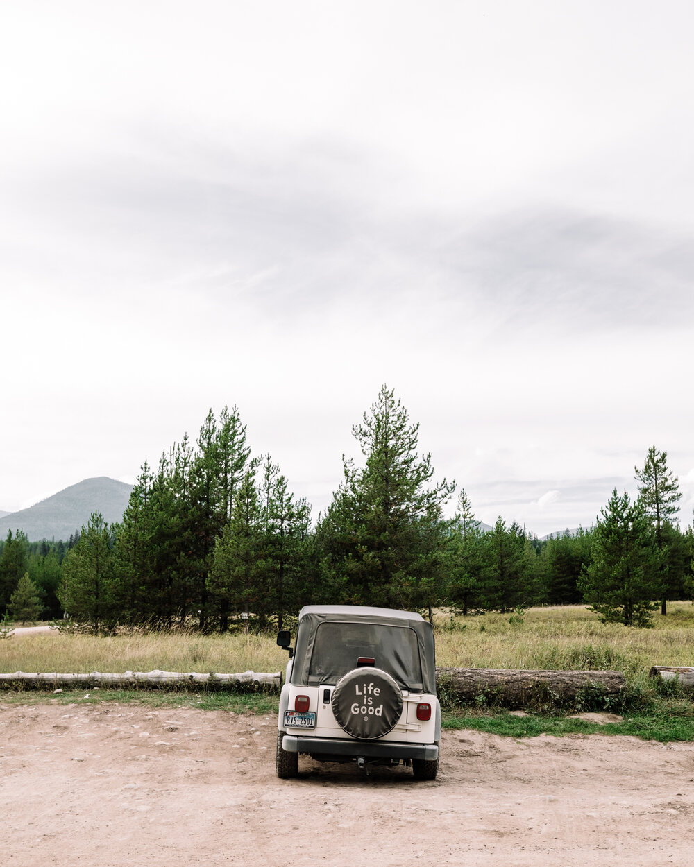Rachel Off Duty: Jeep in Front of Trees in Glacier National Park
