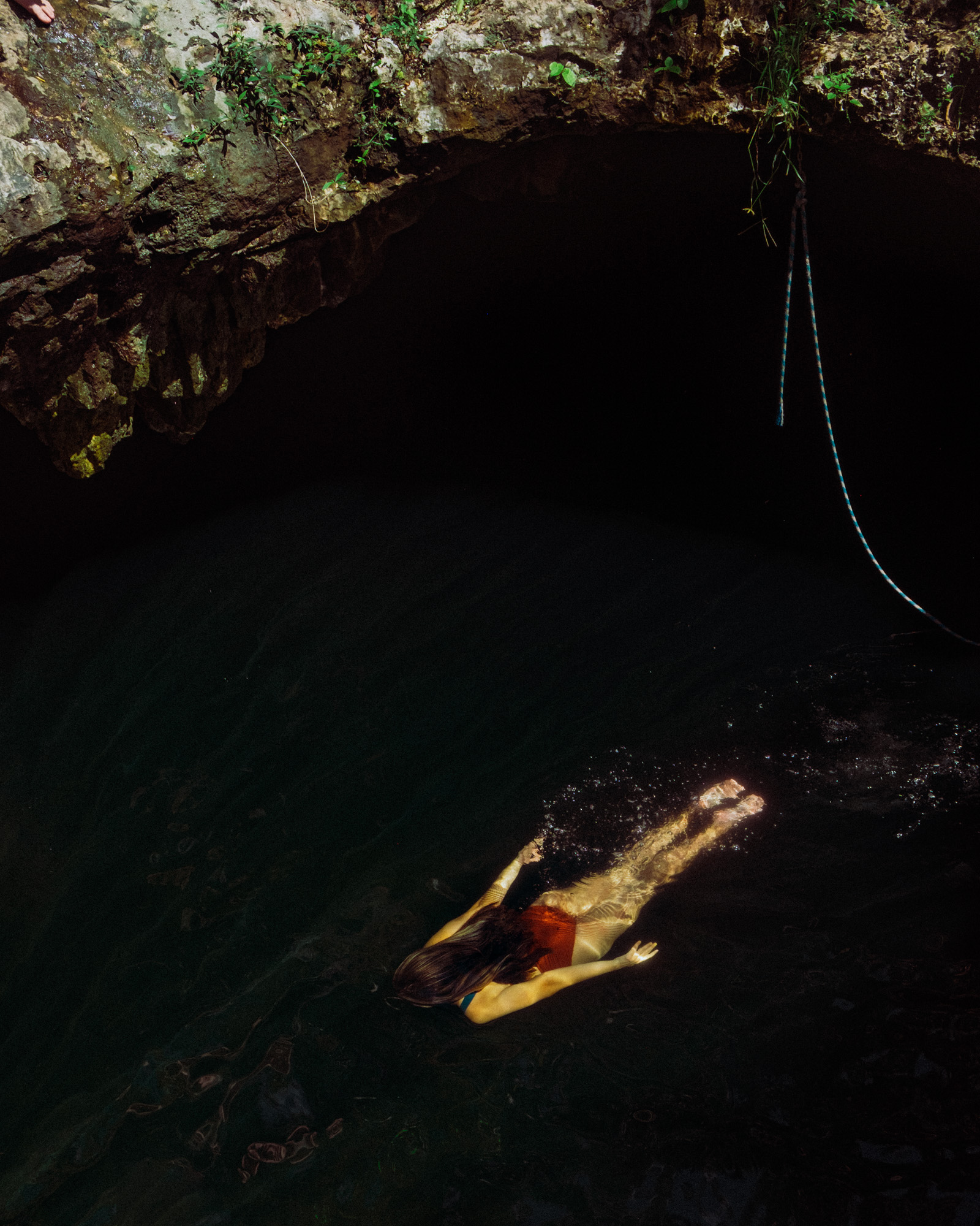 Rachel Off Duty: A Woman Swimming in Cenote Calavera, Tulum, Mexico