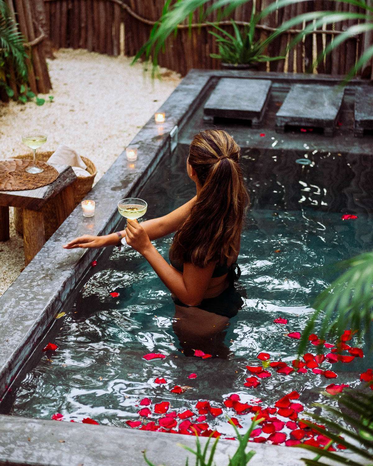 Rachel Off Duty: A Woman in a Pool with Rose Petals, Candles, and Champagne