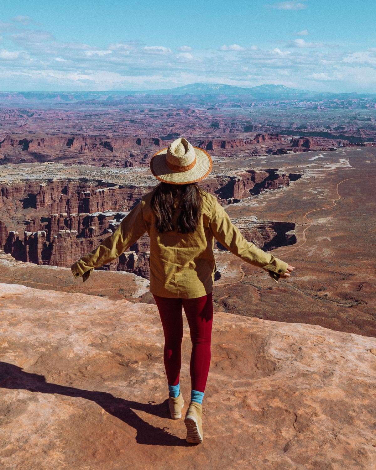 Rachel Off Duty: A Woman in a Khaki Jacket and Red Yoga Pants Admires the View at Canyonlands
