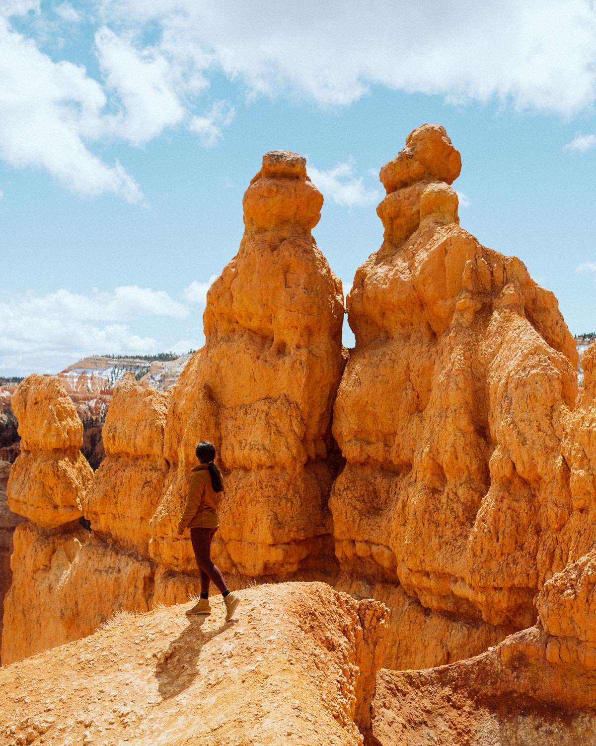 Rachel Off Duty: A Girl in a Yellow Jacket Stands Next to Hoodoos in Bryce Canyon